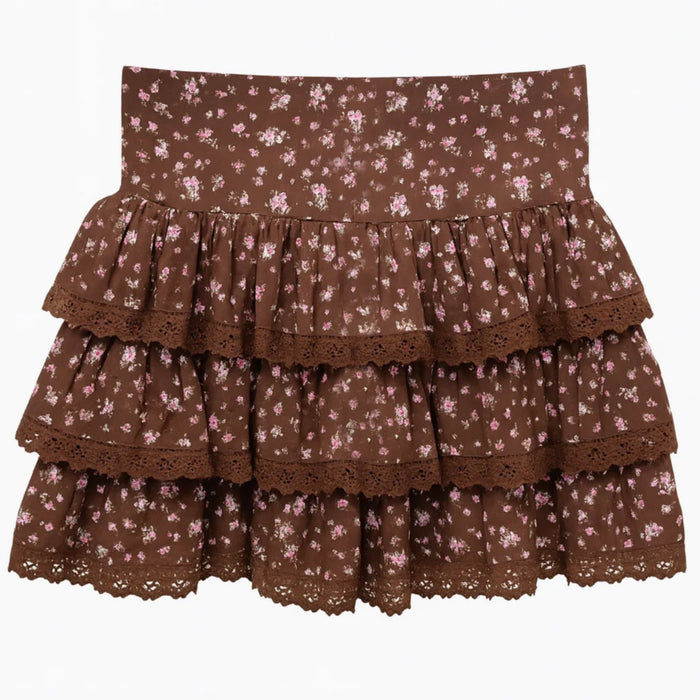Melody skirt has a flat front waist & elastic waist at the back. It has 3 flouncy tiers, each tier had solid brown crochet lace at hem. Skirt is in a beautiful pinkish ditsy floral on a chocolate background.