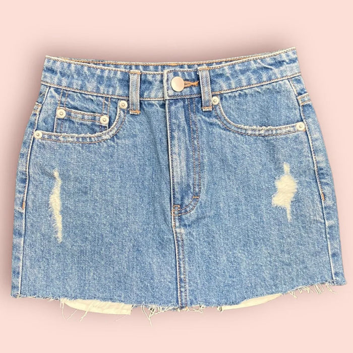 Katie J NYC’s junior's Miami denim skirt with a frayed raw-cut hem and a 5-pocket design, in a medium wash.