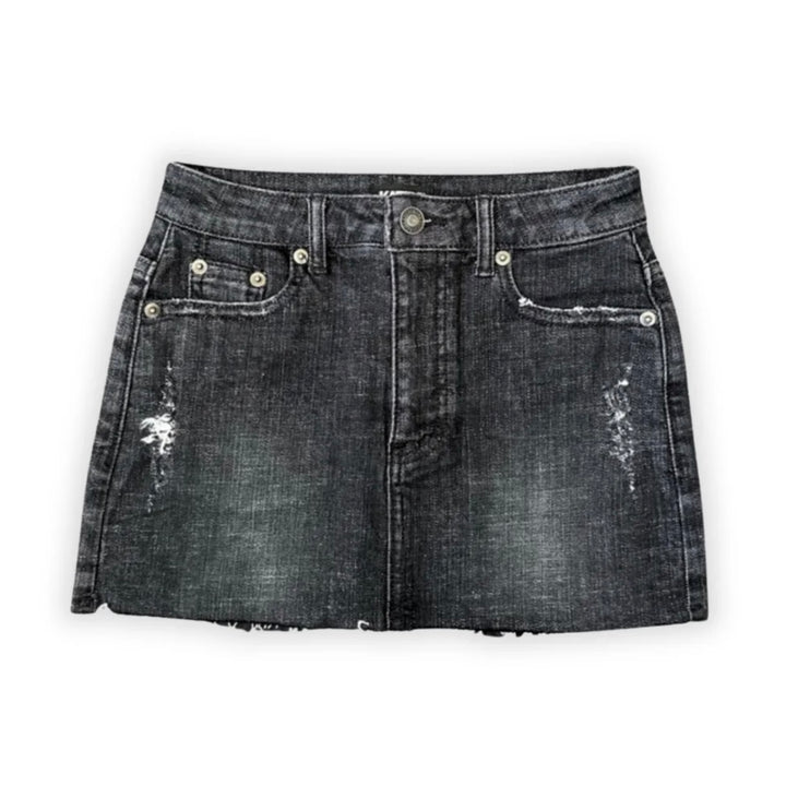 Katie J NYC’s Tween Miami denim skirt with a frayed raw-cut hem and a 5-pocket design, in a vintage black wash.